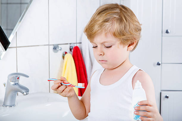istock Lovely toddler boy brushing his teeth, indoors 546777820