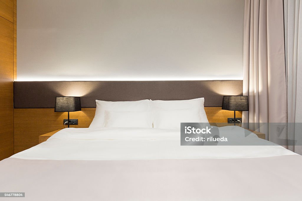 Luxury hotel bedroom in the evening Bed - Furniture Stock Photo