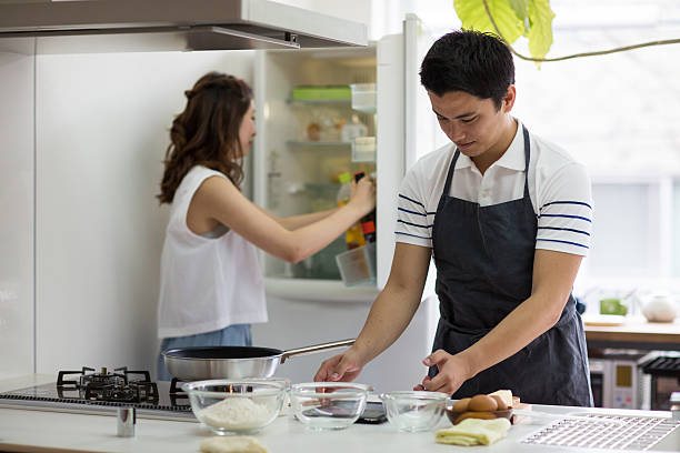 istock Young couple cooking together in a modern kitchen 546779664