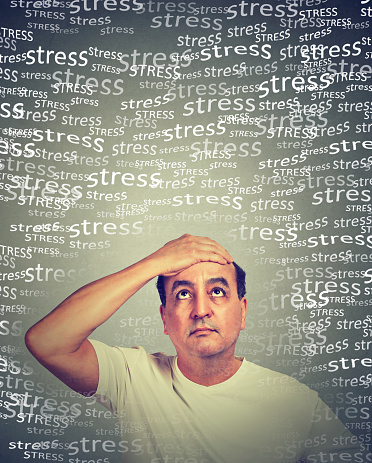 Stressed middle aged man isolated on gray wall background