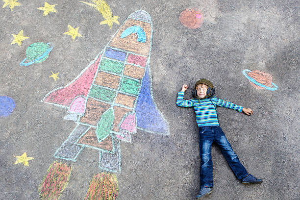istock little kid boy flying by a space shuttle chalks picture 546782488