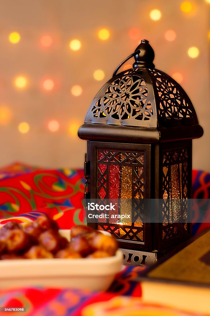 Ramadan Background Ramadan Background - Lantern, dish of dates and Quraan on Ramadan colorful fabrics Arabia Stock Photo