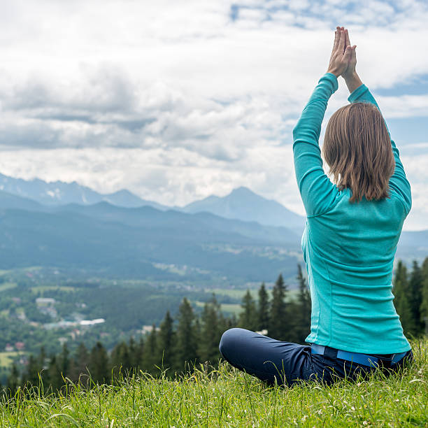 istock Woman Meditate at the Mountains 546783250