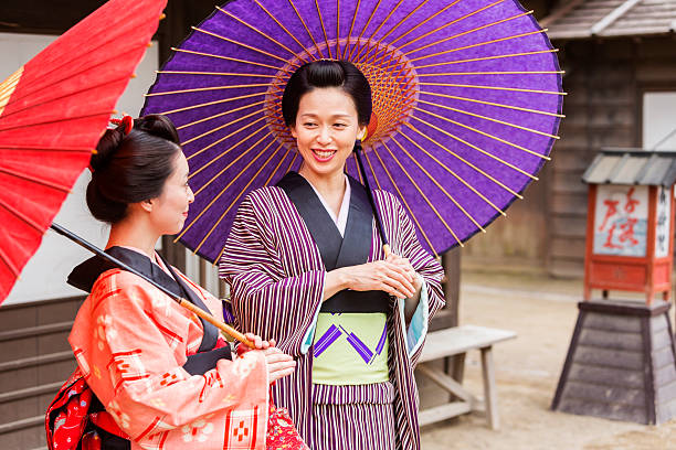 istock Traditionally Dressed Japanese Women in Kimonos with Umbrellas 546783320