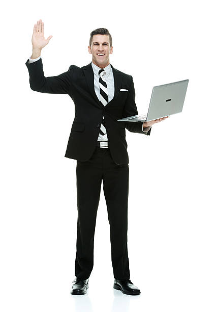 istock Smiling businessman waving hand with laptop 546786116