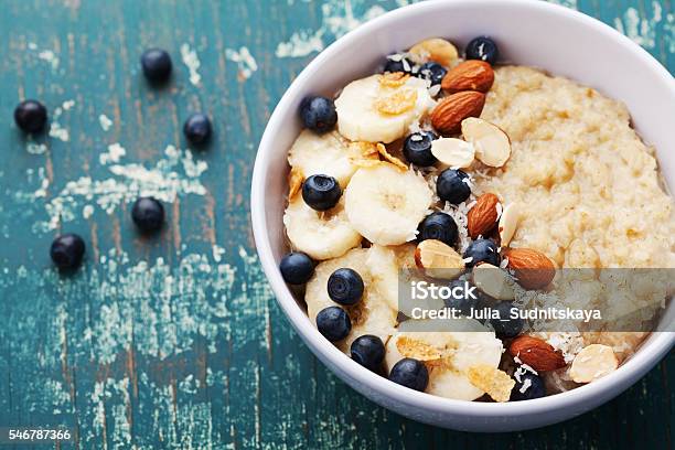 Bowl Of Homemade Oatmeal Porridge With Banana Blueberries And Almonds Stock Photo - Download Image Now