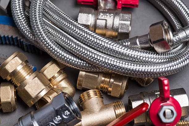 istock Adjustable spanner with assorted plumbing fittings and hose on grey 546788658