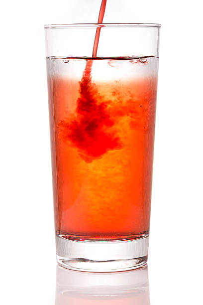 Fresh tomato juice being poured from bottle