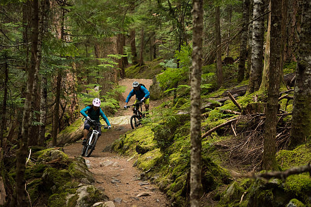 istock Couple mountain biking through a forest 546789980