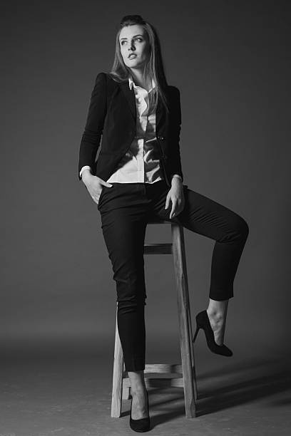 istock girl model posing in the Studio on a Chair 546792230