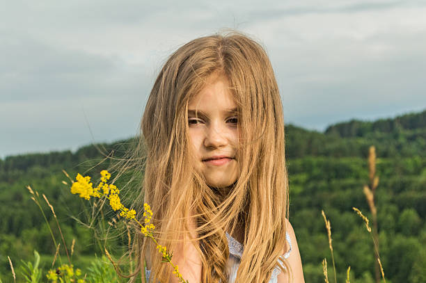 sunny の少女 - blond hair overcast sun sky ストックフォトと画像