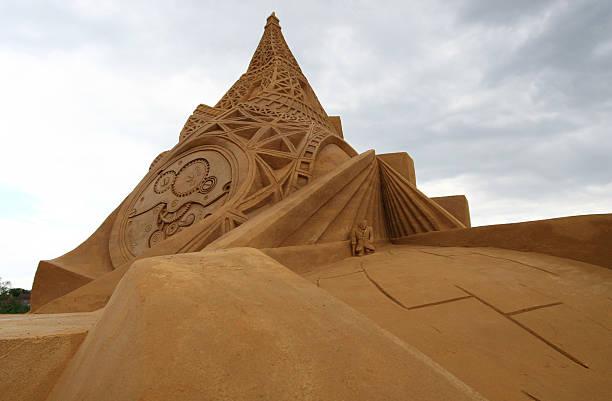 istock Sand sculpture of an Eiffel tower merged with a watch. 546793408