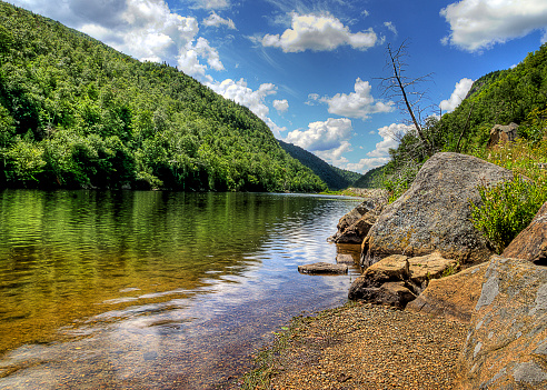 A peaceful river in the Adirondacks on a bright, sunny, summer day