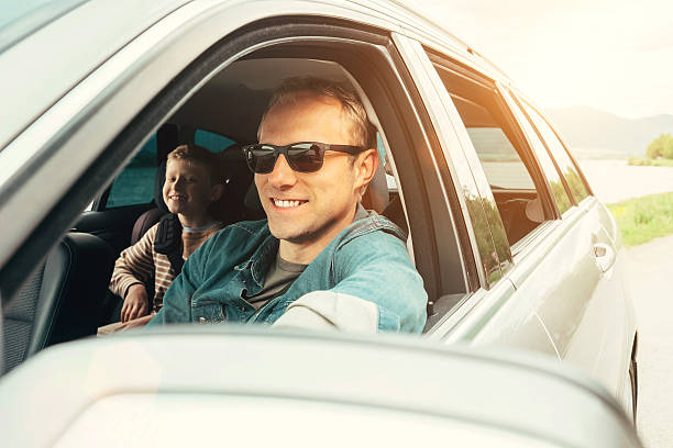 istock Father and son look out from car window 546794236