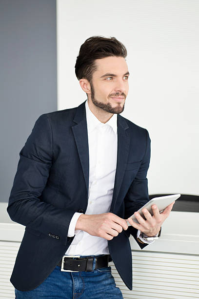 istock Serious businessman holding tablet, thinking about new project. 546794800
