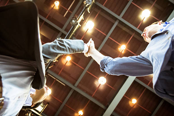 istock High-five by the two business people 546795244