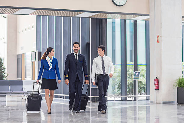 istock Pilot and flight attendants walking at the airport 546795282