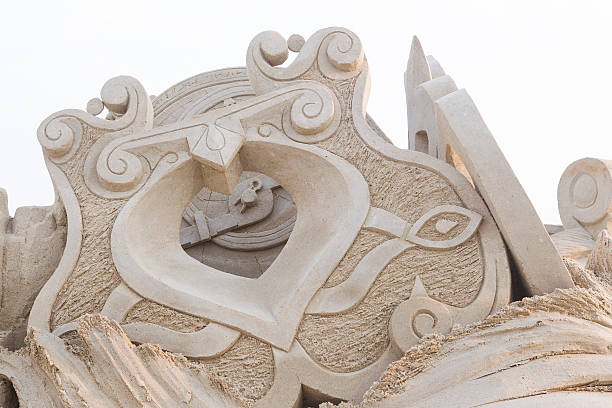 Sand sculpture of a ancient arabic jewelry with a compass in the back. This sand sculpture is made by Bouke Atema and photograped by Bouke Atema.