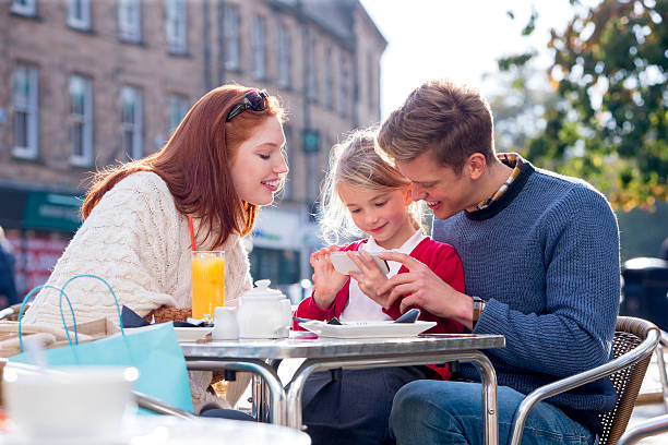 istock Family of Three Looking at a Smartphone 546795976