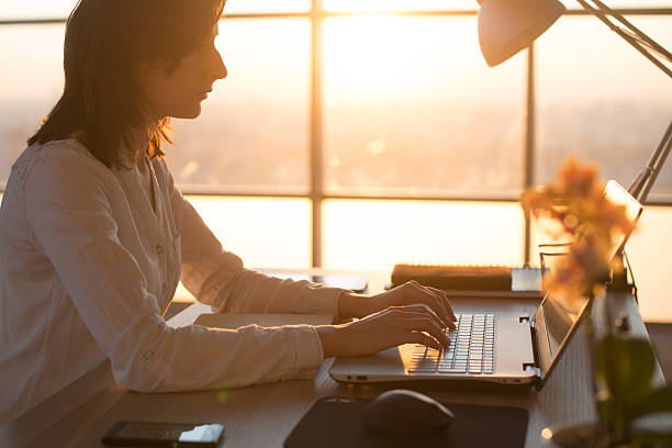 istock Side view photo of a female programmer using laptop, working 546797238