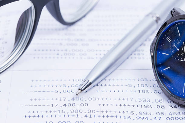 istock Finance Concepts, pen, watch and glasses with passbook 546798336