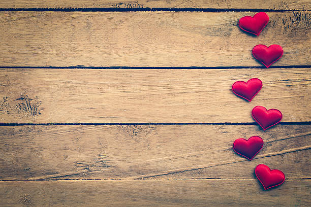 istock Valentines Day background and red hearts on wood 546798346