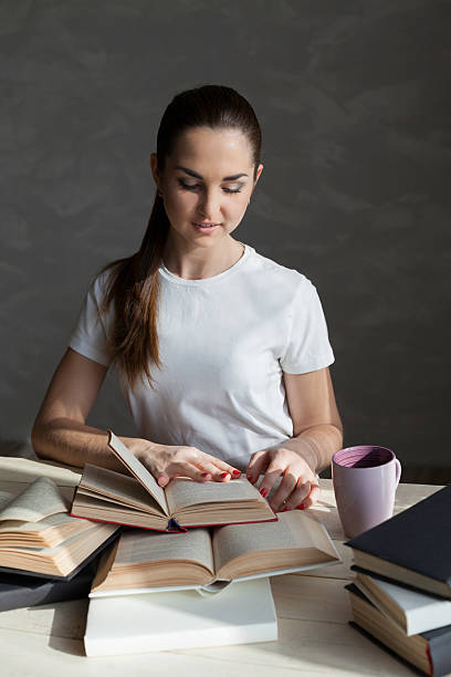 istock girl is preparing for the exam and reads a book 546800374