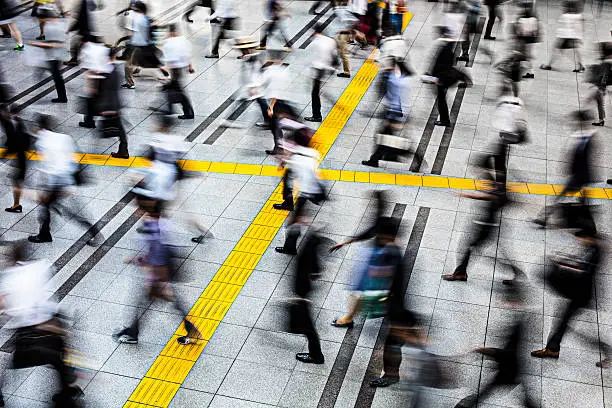 Motion blur of Japanese commuters in a station at Tokyo.