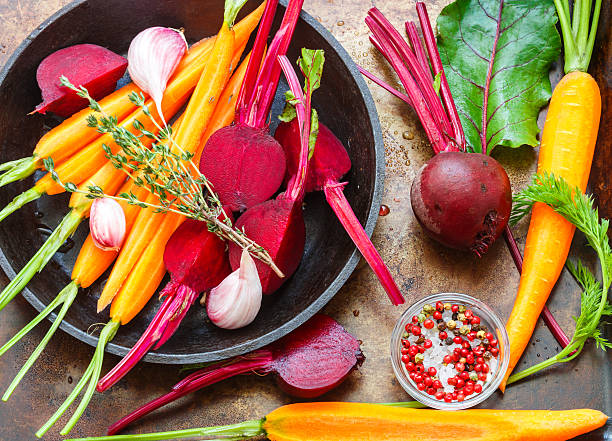 istock Beets and carrots ready for roasting with olive oil,  spices 546803832