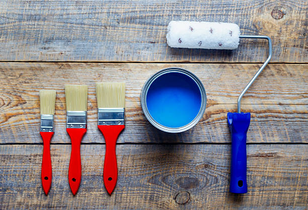 istock painting with can of blue paint and brushes top view 547009836