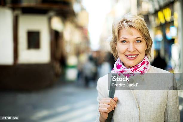 Cheerful Retiree Woman Having A Walk In City Stock Photo - Download Image Now - Women, One Woman Only, 50-54 Years