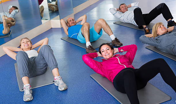 istock people training in a gym on sport mats 547012152
