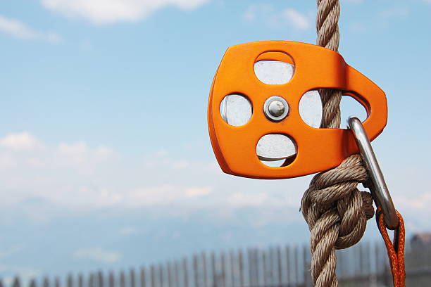Orange Climbing Pulley with rope and carabiner stock photo