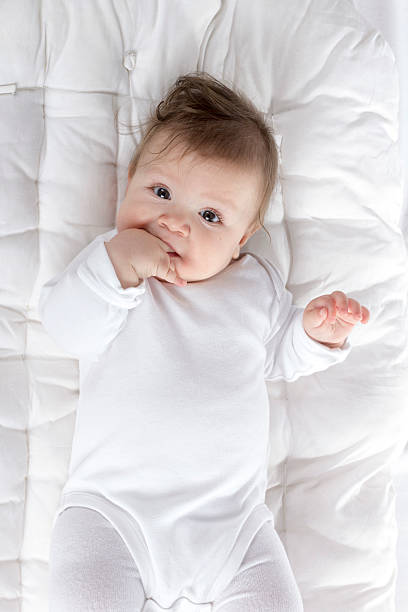 istock teething baby with hand in mouth 547013594