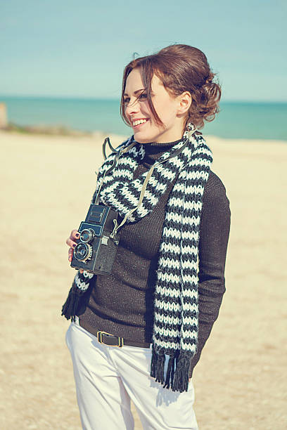 istock Beach woman with vintage retro camera 547016904