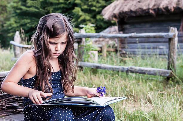 istock little girl reading an interesting book 547018280