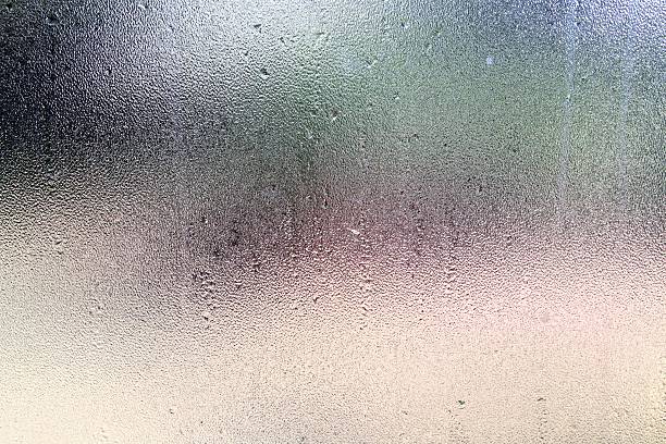 istock Raindrops and condensation on frosted glass window pane 547018386