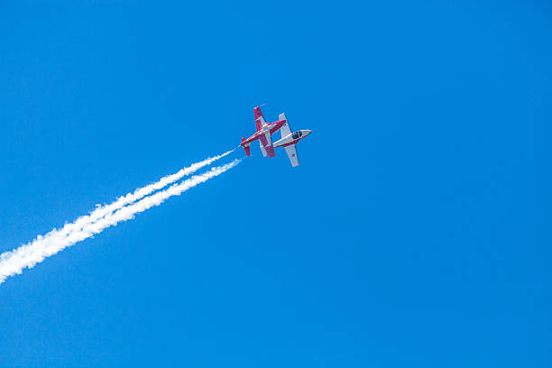 Snowbirds in blue sky Gatineau, Canada - June 30, 2016: The Wings over Gatineau Airshow is an airshow at the Gatineau Executive Airport. This image shows the Canadian Forces Snowbirds aerial demonstration team flying in the blue sky. stunt airplane airshow air vehicle stock pictures, royalty-free photos & images