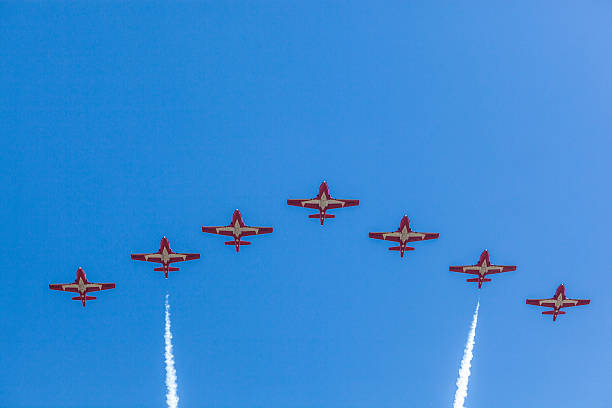 Snowbirds in blue sky Gatineau, Canada - June 30, 2016: The Wings over Gatineau Airshow is an airshow at the Gatineau Executive Airport. This image shows the Canadian Forces Snowbirds aerial demonstration team flying in the blue sky. stunt airplane airshow air vehicle stock pictures, royalty-free photos & images