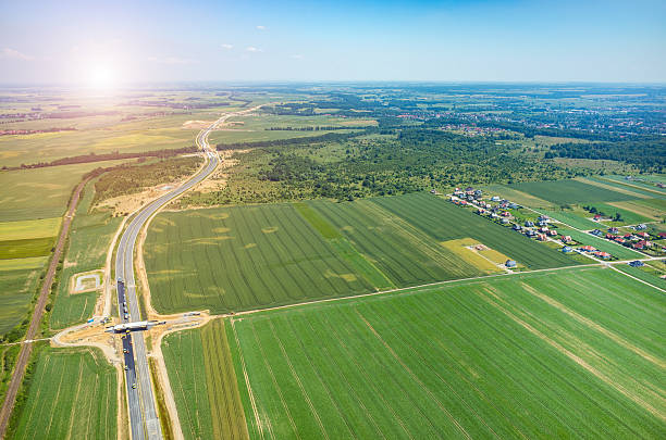 istock Sunset above new road construction site aerial view 547019692