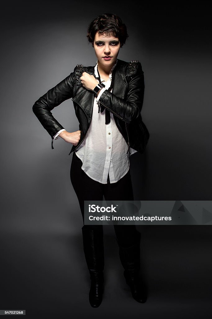 Goth Style Model with Smartwatch Fashion model wearing black goth style leather with stylish smartwatch or wrist watch.  The model fashion style represents a punk subculture.  She is modeling a modern smartwatch.  The image depicts fashion and technology. Emo Stock Photo