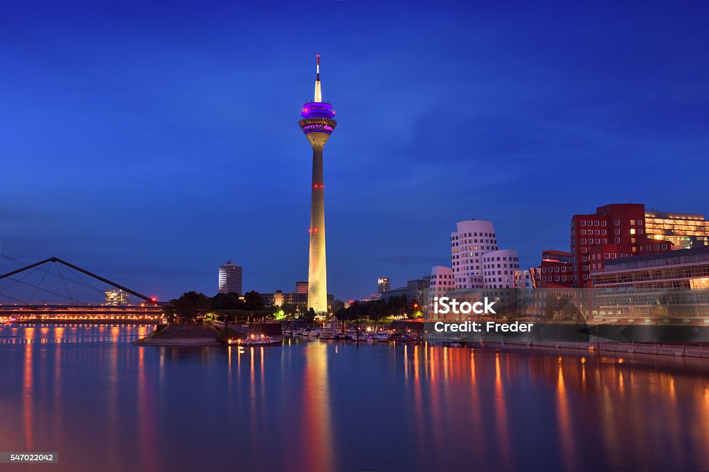 Dusseldorf, Germany View of Düsseldorf during the blue hour at the Rhine river with the Rheinturm Tower and the media harbor. Düsseldorf Stock Photo