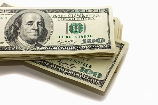 istock hundred-dollar bills in a pile on a white background, 547022854