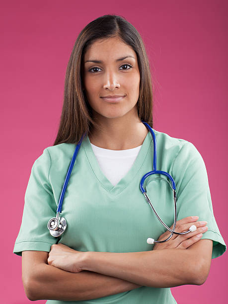 Midsection of nurse making heart shape with hands isolated over white background. Horizontal shot.