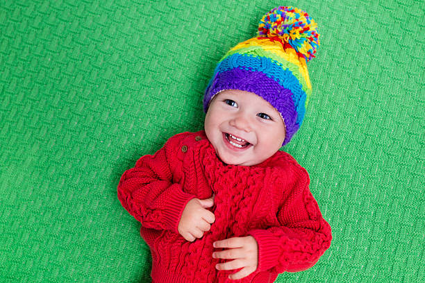 istock Laughing little baby in warm knitted hat 547026090