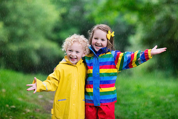 istock Kids playing in the rain 547026410