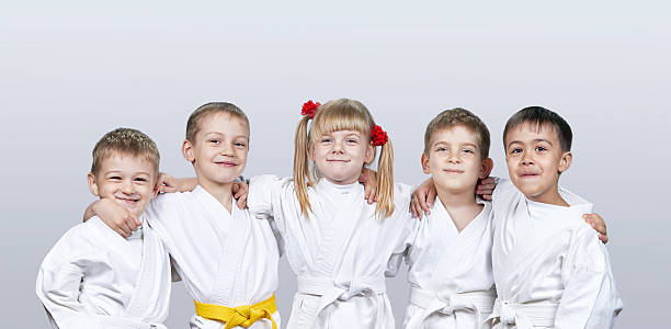 istock Cheerful children in karategi on a gray background 547026698