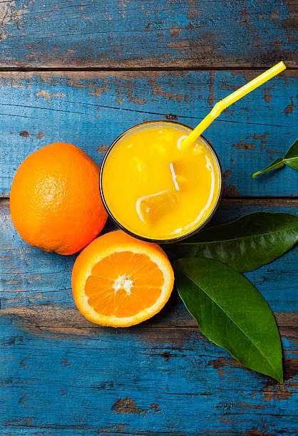 istock Glass of freshly squeezed orange juice and fresh oranges 547027072