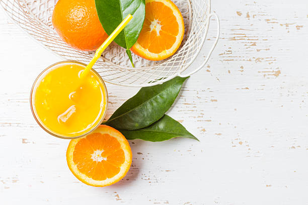 istock Glass of freshly squeezed orange juice and fresh oranges 547027862