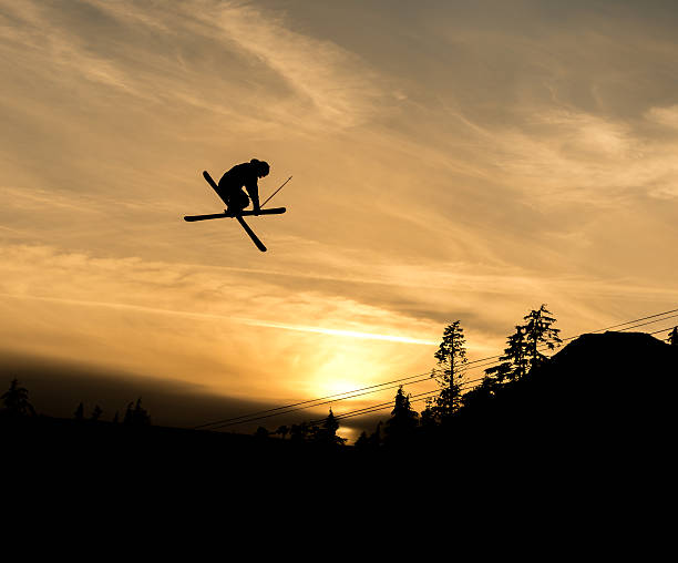 istock Skier doing a grab off  jump in the sunset 547028282